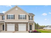 Charming townhome with stone accents, dual garage, and well-maintained landscaping at 5563 Henley Ridge Dr, Graham, NC 27253