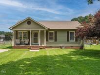 Charming single-story home with a well-maintained lawn, a covered front porch and brick foundation at 635 Raymond Dr, Wendell, NC 27591