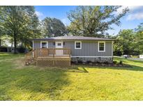 Charming single-story home with a wooden porch and freshly landscaped front yard at 703 Whitsett Ave, Gibsonville, NC 27249