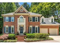 Stately brick home with a two car garage and mature landscaping at 105 Windfall Ct, Cary, NC 27518