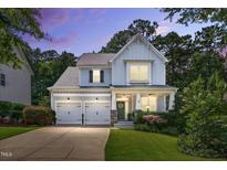 Charming two-story home features a two car garage, manicured lawn and inviting front porch at 108 Market Cross Ct, Holly Springs, NC 27540