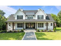 Stunning two-story home with a welcoming front porch and beautifully landscaped front yard at 125 Attena Way, Zebulon, NC 27597