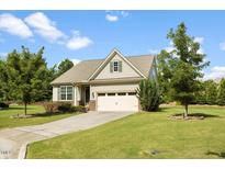 Charming single-story home with a well-manicured lawn, attached garage, and inviting curb appeal at 1705 Bodwin Ln, Apex, NC 27502