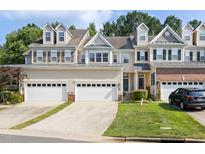 Charming townhouse with attached garages, well-maintained lawn, and inviting curb appeal in a desirable neighborhood at 204 Towne Ridge Ln, Chapel Hill, NC 27516