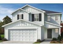 Charming two-story home featuring a two-car garage and inviting curb appeal with lush landscaping at 236 Norman Ave, Lillington, NC 27546