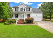 Charming two-story home with a well-manicured lawn and attached two car garage at 2430 Josephine Rd, Garner, NC 27529