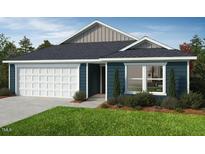 Charming single-story home with a two-car garage, blue siding, and a well-manicured lawn at 246 Norman Ave, Lillington, NC 27546