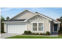 Charming one-story home with neutral siding, white trim, a two-car garage, and well-maintained landscaping at 256 Norman Ave, Lillington, NC 27546