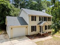 Charming two-story home with a well-manicured lawn, attached garage, and inviting front porch at 308 Fleming Dr, Durham, NC 27712