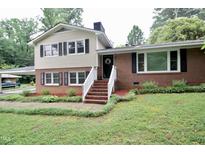 Charming brick and siding two-story home with inviting front steps and a well-maintained yard at 3812 Vesta Dr, Raleigh, NC 27603