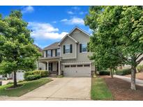 Two-story home with a two-car garage, a well-manicured lawn, and mature trees at 428 Mill Station Ln, Wendell, NC 27591