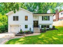 Charming two-story home features a freshly painted exterior, manicured landscaping, and an attached garage at 4349 Pickwick Dr, Raleigh, NC 27613