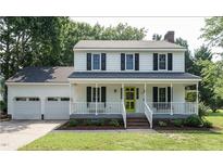 Charming two-story home with a welcoming front porch, bright yellow door, and well-manicured lawn at 505 Commander Dr, Wendell, NC 27591