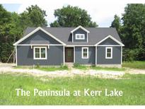 Charming, single-story home featuring gray siding, white trim, and inviting curb appeal in a serene neighborhood at 53 Stonewood Loop Ln, Henderson, NC 27537