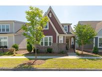 Charming two-story home with brick accents, manicured lawn, and mature landscaping at 6612 Enrichment Ln, Raleigh, NC 27616