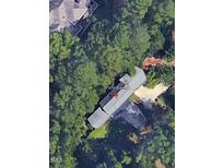 An aerial view of a home surrounded by dense trees, providing privacy and a natural setting at 71010 Russell, Chapel Hill, NC 27517