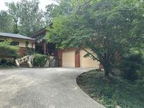 Beautiful home featuring a two-car garage, lush landscaping, and a charming stone staircase at 71010 Russell, Chapel Hill, NC 27517