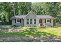 Charming single story home featuring a gray painted brick and siding exterior with a mature landscaped yard at 908 Snow Hill Rd, Durham, NC 27712