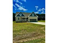Charming one-story home featuring a two-car garage and a covered front porch at 106 Viola Ln, Franklinton, NC 27525