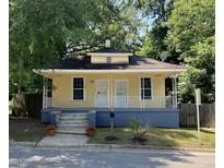 Charming yellow home with a cozy front porch and well-maintained landscaping at 1108 Taylor Street, Durham, NC 27701