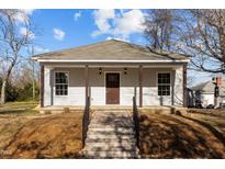 Charming single-story home featuring a welcoming front porch and well-maintained landscaping at 112 Edgewood Dr, Roxboro, NC 27573