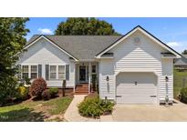 Charming single-Gathering home features a well-maintained lawn, a two-car garage, and a welcoming entrance at 113 Kelly Ln, Clayton, NC 27520