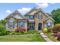 Charming two-story brick and stone home with manicured lawn and colorful landscaping at 1806 Pattersons Mill Rd, Durham, NC 27703