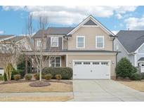Charming two-story home featuring a manicured lawn and a two-car garage at 1985 Firenza Dr, Apex, NC 27502