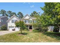 Charming two-story home with a well-manicured lawn, lush landscaping, and inviting curb appeal at 203 Pathwood Ln, Durham, NC 27705