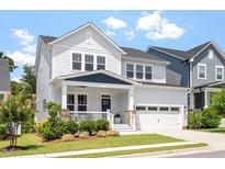 Charming two-story home boasts a manicured lawn and attached garage with a traditional architectural style at 223 Chauncey Cir, Chapel Hill, NC 27516