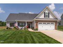 Charming two-story home with a manicured lawn and inviting curb appeal at 2413 Whelen Dr, Graham, NC 27253