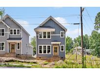Charming two-story home with gray siding, white trim, and a welcoming front porch at 317 W Murray Ave, Durham, NC 27704
