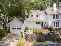 Charming two-story home with landscaped front yard and detached garage at 3811 Carnegie Ln, Raleigh, NC 27612