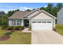 Charming single-story home with a two-car garage, well-manicured lawn, and inviting curb appeal at 515 Legacy Dr, Youngsville, NC 27596