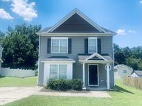 Charming two-story home with gray siding, black shutters, and a well-maintained front yard at 5908 Abbington Way, Raleigh, NC 27610