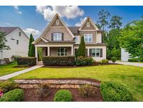 Charming two-story home with a beautifully landscaped front yard and stone accents at 610 Bennett Mountain, Chapel Hill, NC 27516