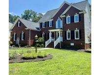 Beautiful two-story brick home with a well-manicured lawn and inviting front entrance at 8512 Barrett Hall Ln, Wake Forest, NC 27587