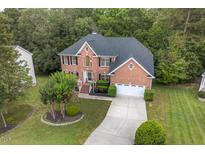 Charming brick home with mature landscaping and a two-car garage, perfect for suburban living at 9 Monteith Ct, Durham, NC 27713