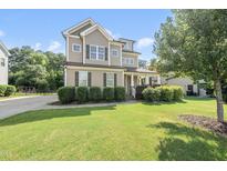 Charming two-story home with manicured lawn, neutral siding and black shutters at 1123 Ambrose Dr, Rolesville, NC 27571