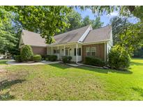 Charming brick home featuring a welcoming front porch, manicured landscaping, and a well-maintained lawn at 150 Williamston Ridge Dr, Youngsville, NC 27596