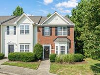 Charming townhome with brick and siding exterior, well-manicured landscaping, and inviting front entrance at 2833 Gross Ave, Wake Forest, NC 27587