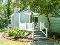 Charming front porch with white railings and steps leading to the welcoming entrance at 2849 Rue Sans Famille, Raleigh, NC 27607