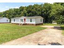 Charming home with a well-maintained lawn and a cozy front porch at 2932 Bramblegate Dr, Mebane, NC 27302