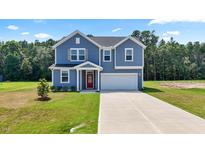 Inviting two-story home featuring a well-manicured lawn, attached garage and classic architectural details at 316 Robert Howe Dr, Fuquay Varina, NC 27526