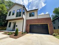 Beautiful two-story home featuring modern design elements and a brick-accented garage at 333 Merrywood Dr, Raleigh, NC 27610