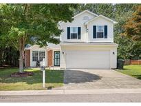Charming two-story home with attached two car garage and attractive landscaping at 3814 Tyler Bluff Ln, Raleigh, NC 27616