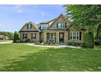 Beautiful brick home with lush lawn and well-manicured landscaping, offering great curb appeal at 39 Wood Stork Ct, Clayton, NC 27520