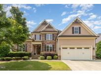 Charming two-story home with a stone facade, well-manicured lawn, and a two-car garage at 4228 Fawn Lily Dr, Wake Forest, NC 27587