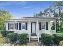 Charming single story home with covered front porch, tidy landscaping, and white exterior at 448 Chinaberry Ln, Angier, NC 27501