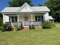 Charming two-story home with a front porch and landscaped yard at 462 Ashland Dr, Goldston, NC 27252